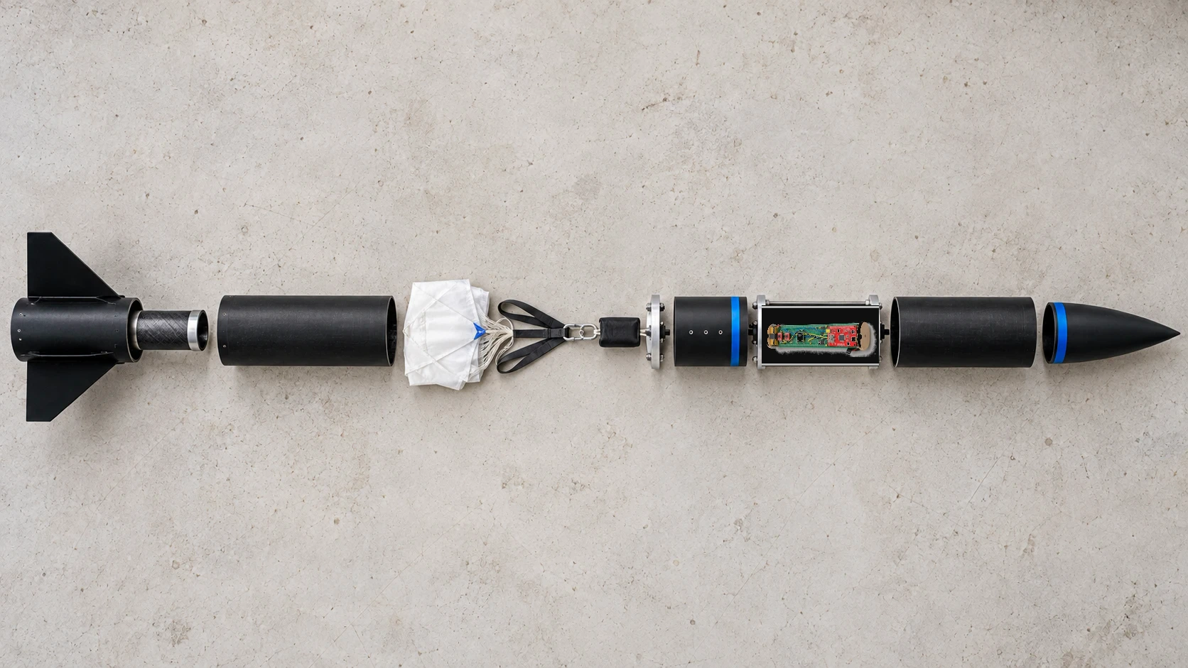 An exploded view of the black rocket with its main internal sections separated